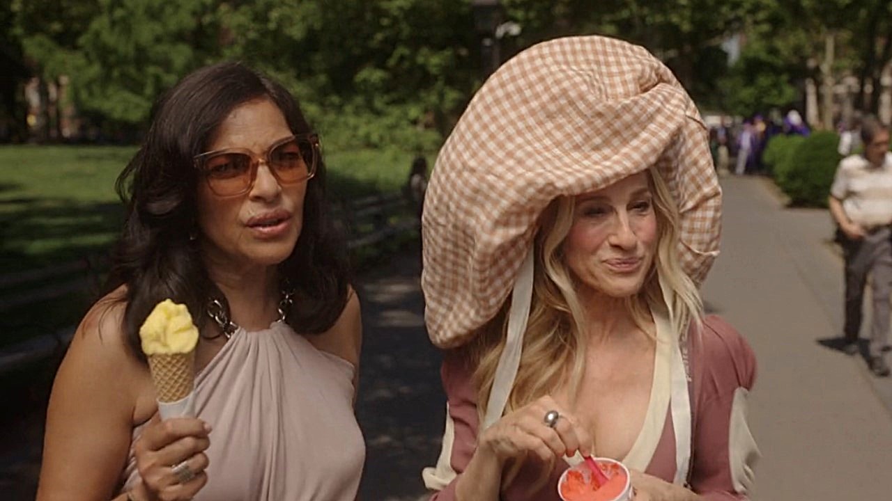 Sarita Choudhury and Sarah Jessica Parker as Carrie Bradshaw wearing a big hat in And Just Like That Season 3 premiere.