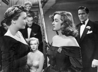 two women dressed in ballgowns have a confrontation in the movie all about eve