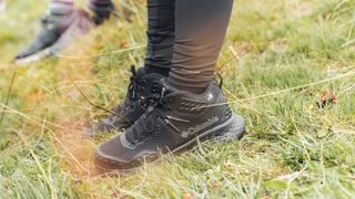 Hiker's feet wearing the Columbia Konos TRS outdry Mid Hiking Shoe