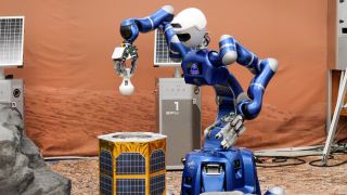 A humanoid robot leans over a golden box with solar panels.