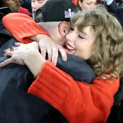 Taylor Swift hugs Travis Kelce at the AFC championships in 2024