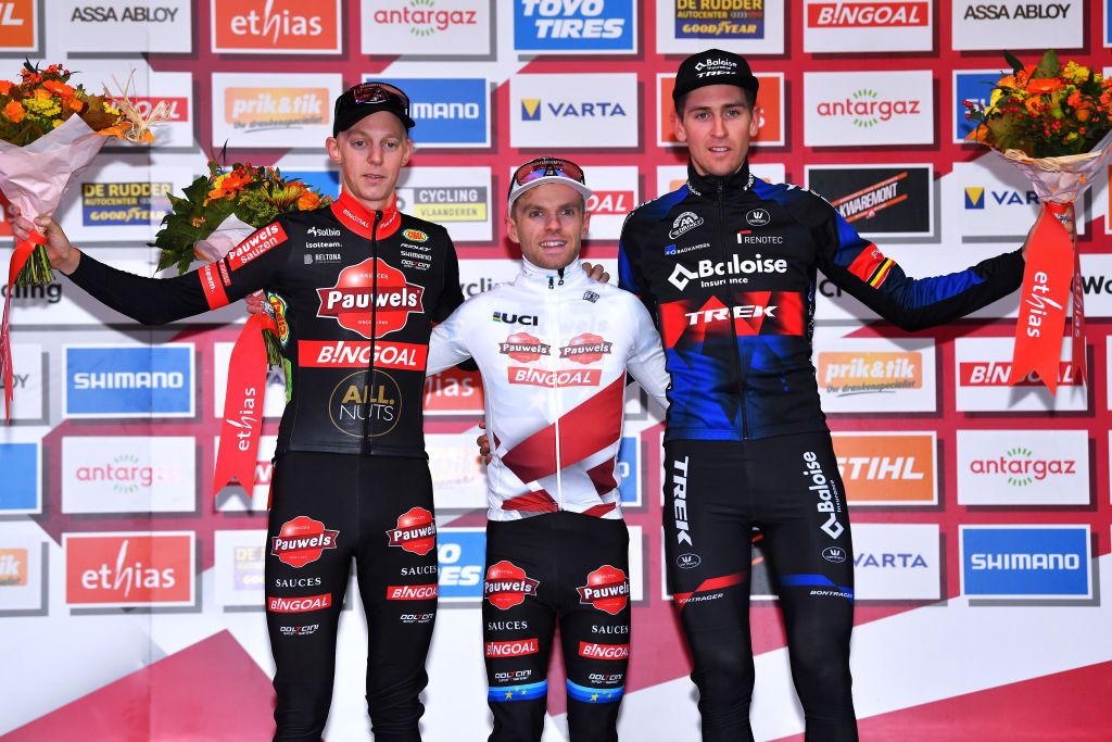 OVERIJSE BELGIUM OCTOBER 31 LR Michael Vanthourenhout of and Team Belgium Pauwels Sauzen Bingoal on second place race winner Eli Iserbyt of Belgium and Team Pauwels Sauzen Bingoal White UCI CycloCross Worldcup Leader Jersey and Toon Aerts of Belgium and Team Baloise Trek Lions on third place pose on the podium ceremony after the 62nd Druivencross Overijse UCI CycloCross Worldcup 2021 Mens Elite DruivencrossOverijse CXWorldCup UCIcyclocrossWC on October 31 2021 in Overijse Belgium Photo by Luc ClaessenGetty Images