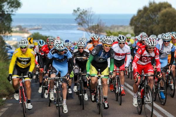 The peloton heads up a climb