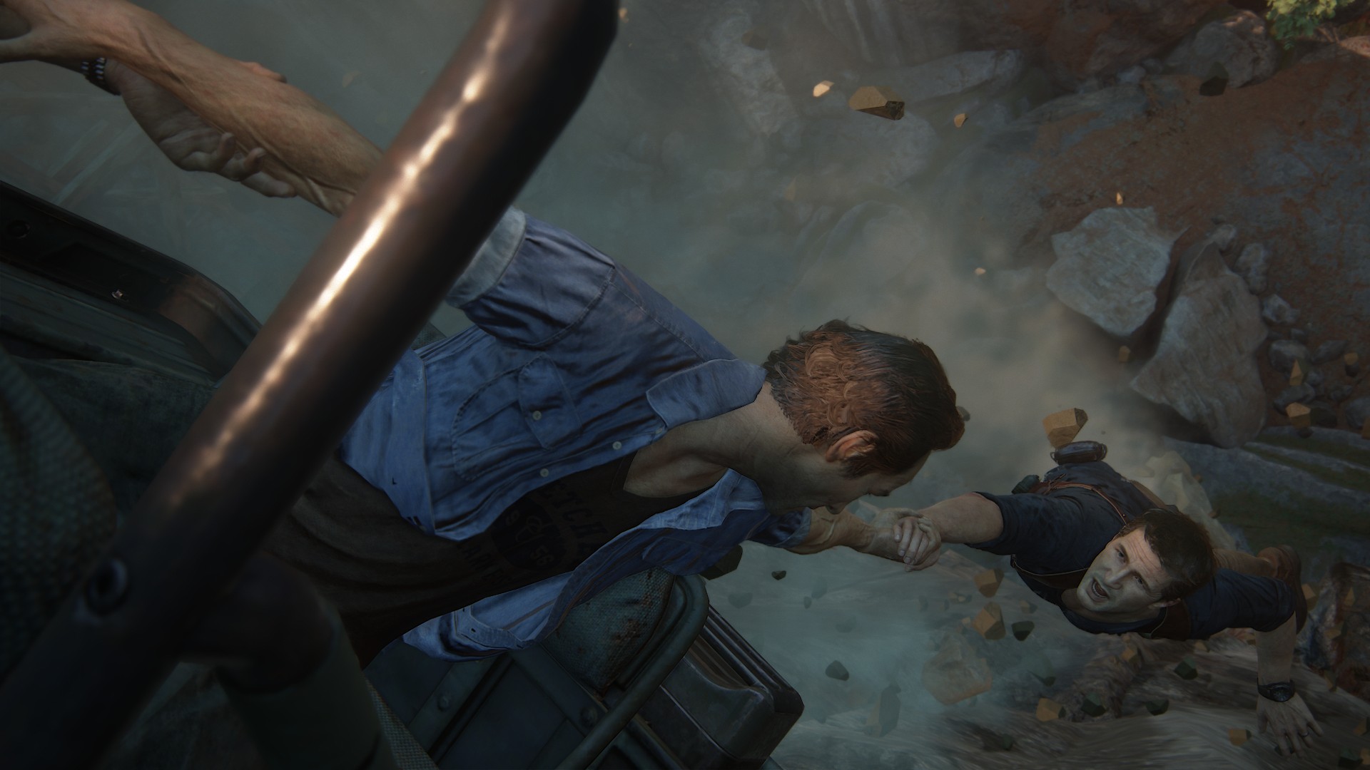 Sam grabs Nathan from the back of a truck while teetering on a cliff in Uncharted 4, for PS4