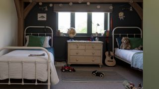 children's bedroom with twin single beds and chest of drawers