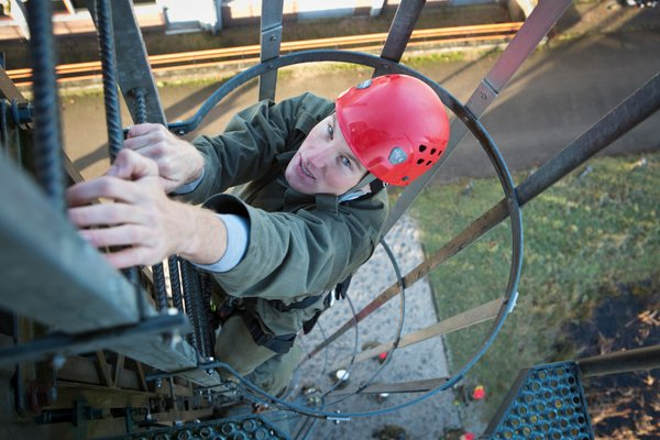 Mike Teunissen looks a little nervous as he climbs up the ladder