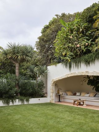 backyard with sheltered cave nook and palm trees by Wyer & Co