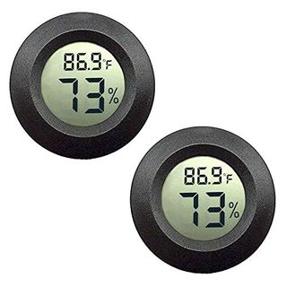 Two round black plastic hydrometers beside one another with large digital number displays