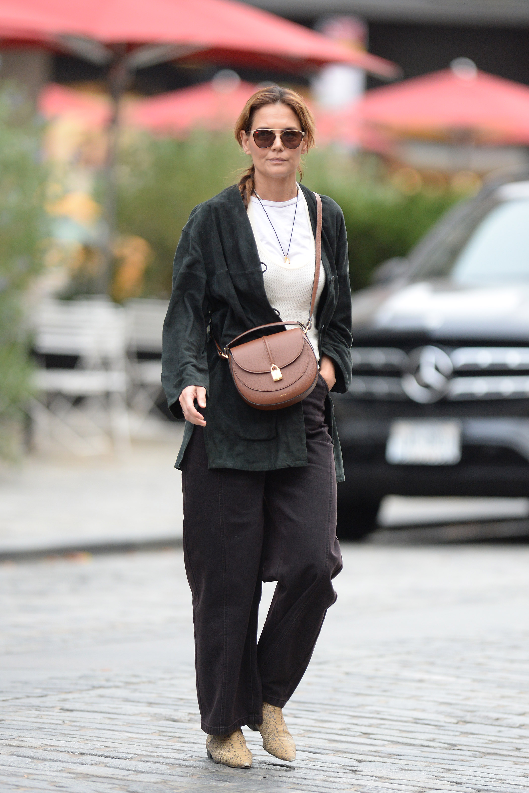 Katie Holmes was spotted in New York wearing a crossbody DeMellier bag and snakeskin boots