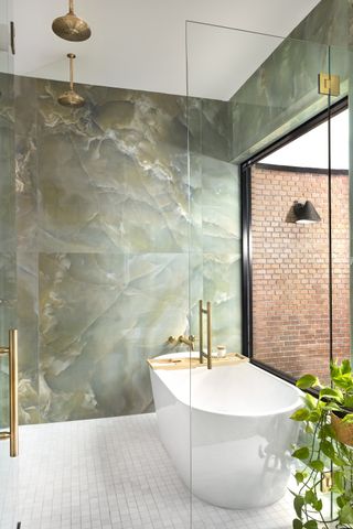 zen bathroom with jade-inspired tile, freestanding bath and large window