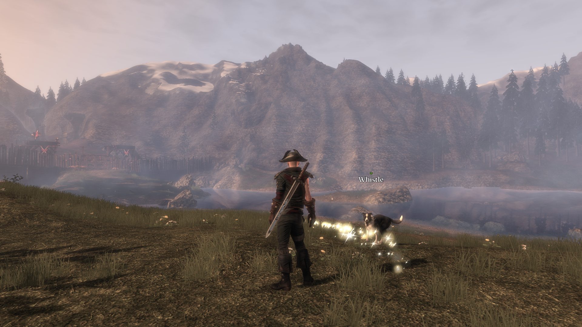 Fable 3 screenshot of hero looking across valley at a bandit camp with mountains and trees in backdrop.