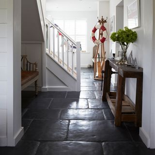 hallwya with white walls and stone flooring