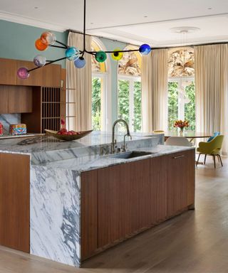 kitchen with marble island and colorful light arched windows