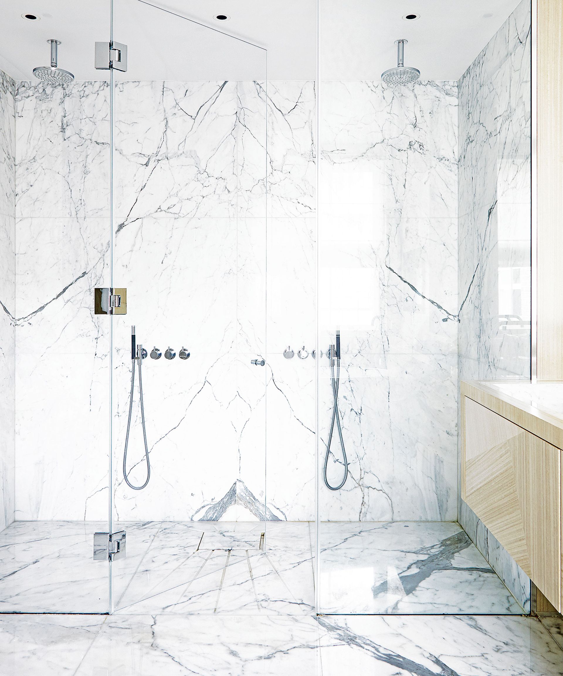 Walk in shower ideas with marble material and double shower head