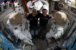 ESA astronaut Luca Parmitano (left) and NASA astronaut Andrew Morgan work on U.S. spacesuits they will wear on a spacewalk scheduled for Jan. 25.