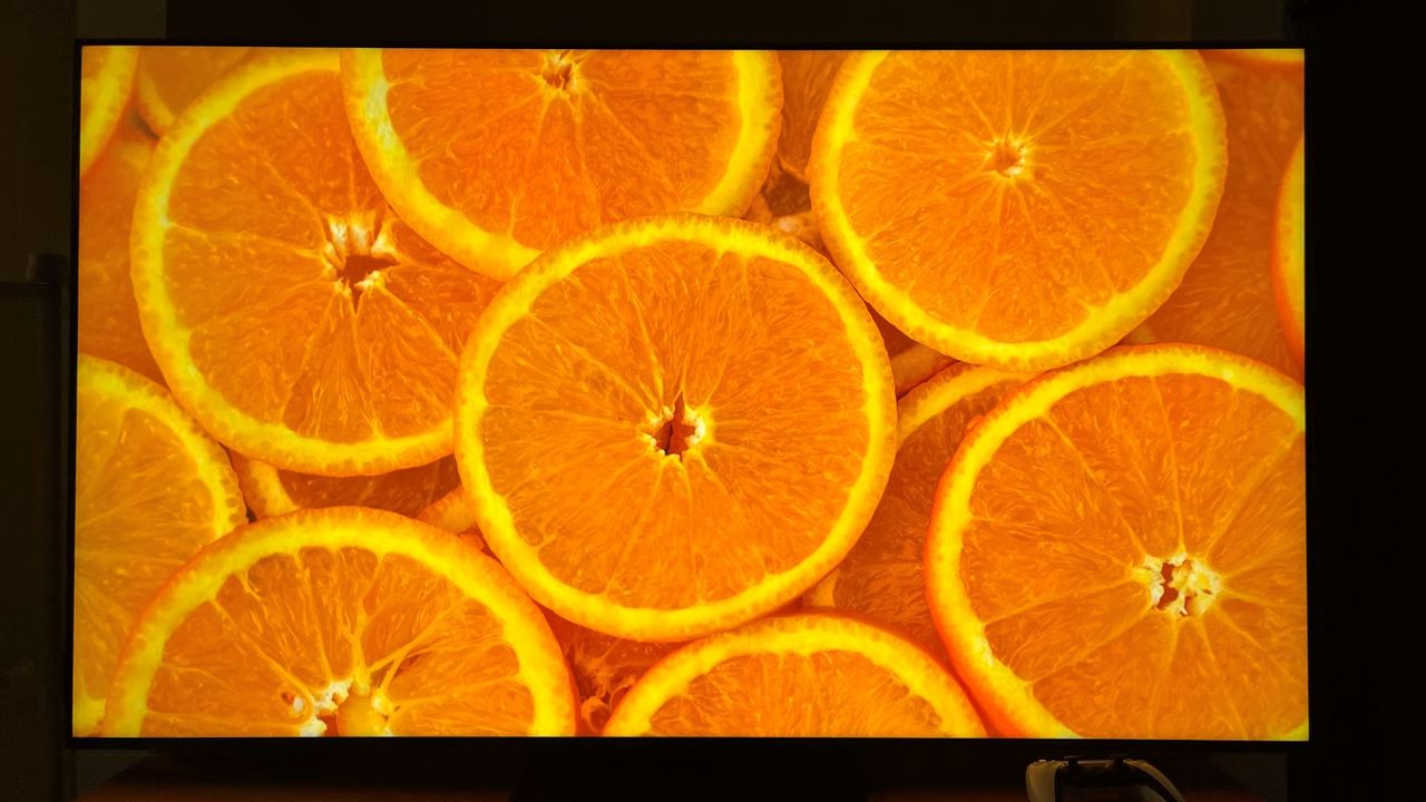 TCL QM7K showing image of oranges on screen