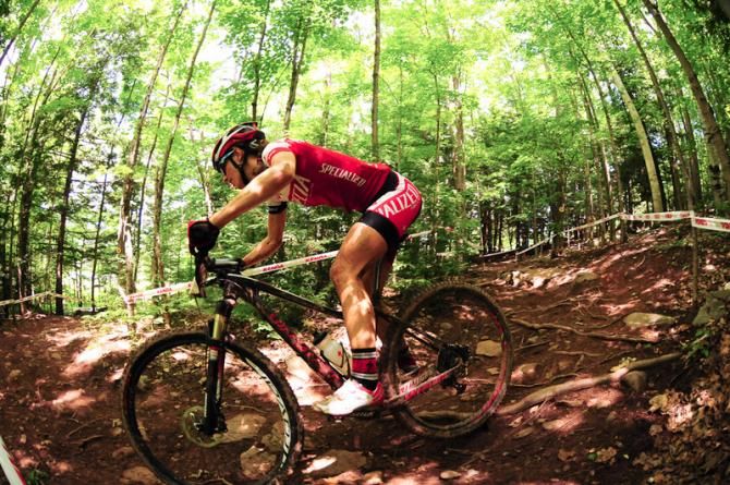 Lea Davison (Specialized) alone in the woods