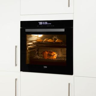 White kitchen with stainless steel handles and built-in Beko oven