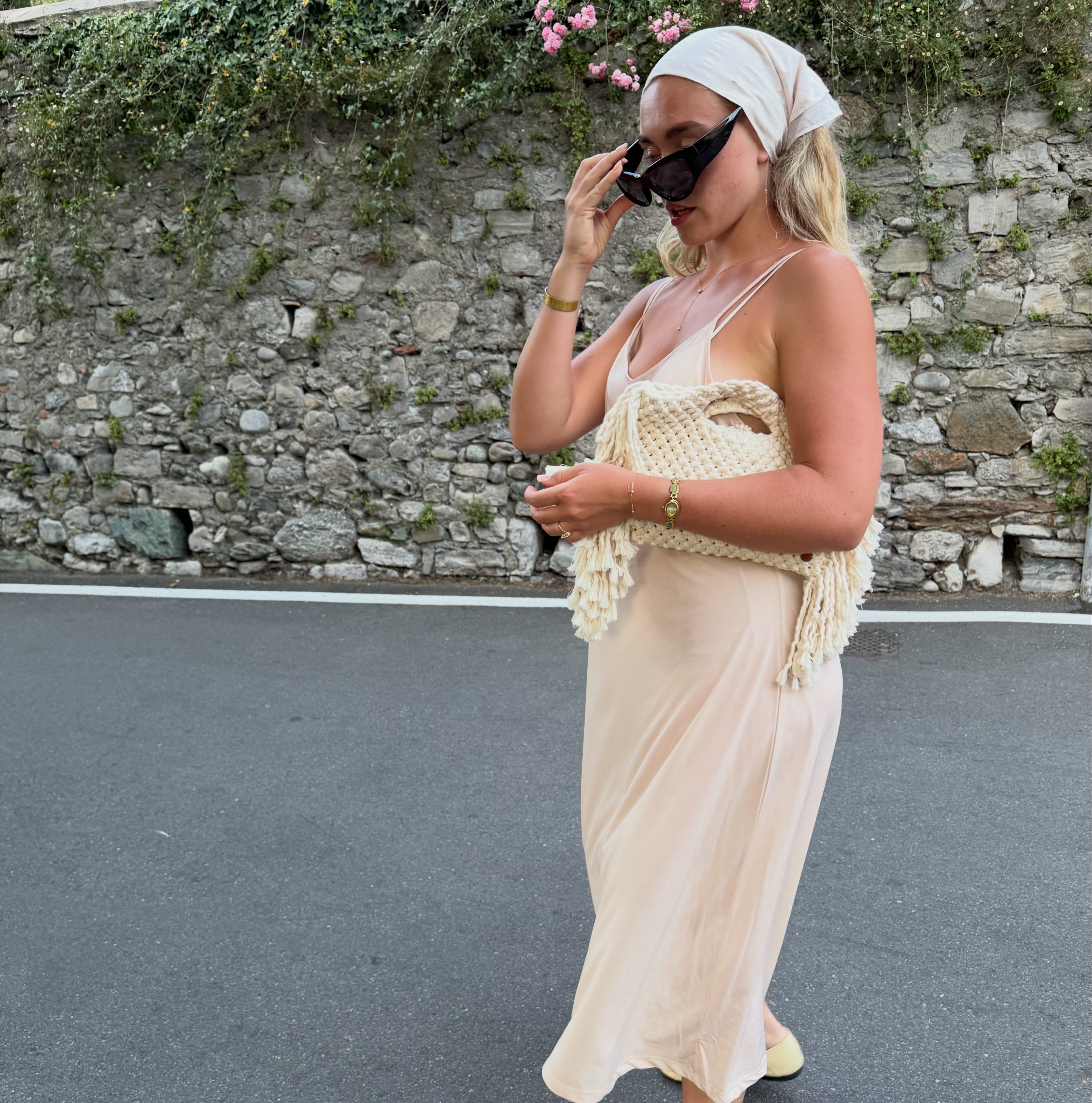 A woman wearing a silk head scarf.