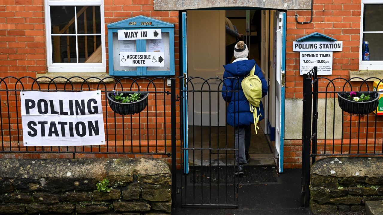 A woman arrives at the village polling station