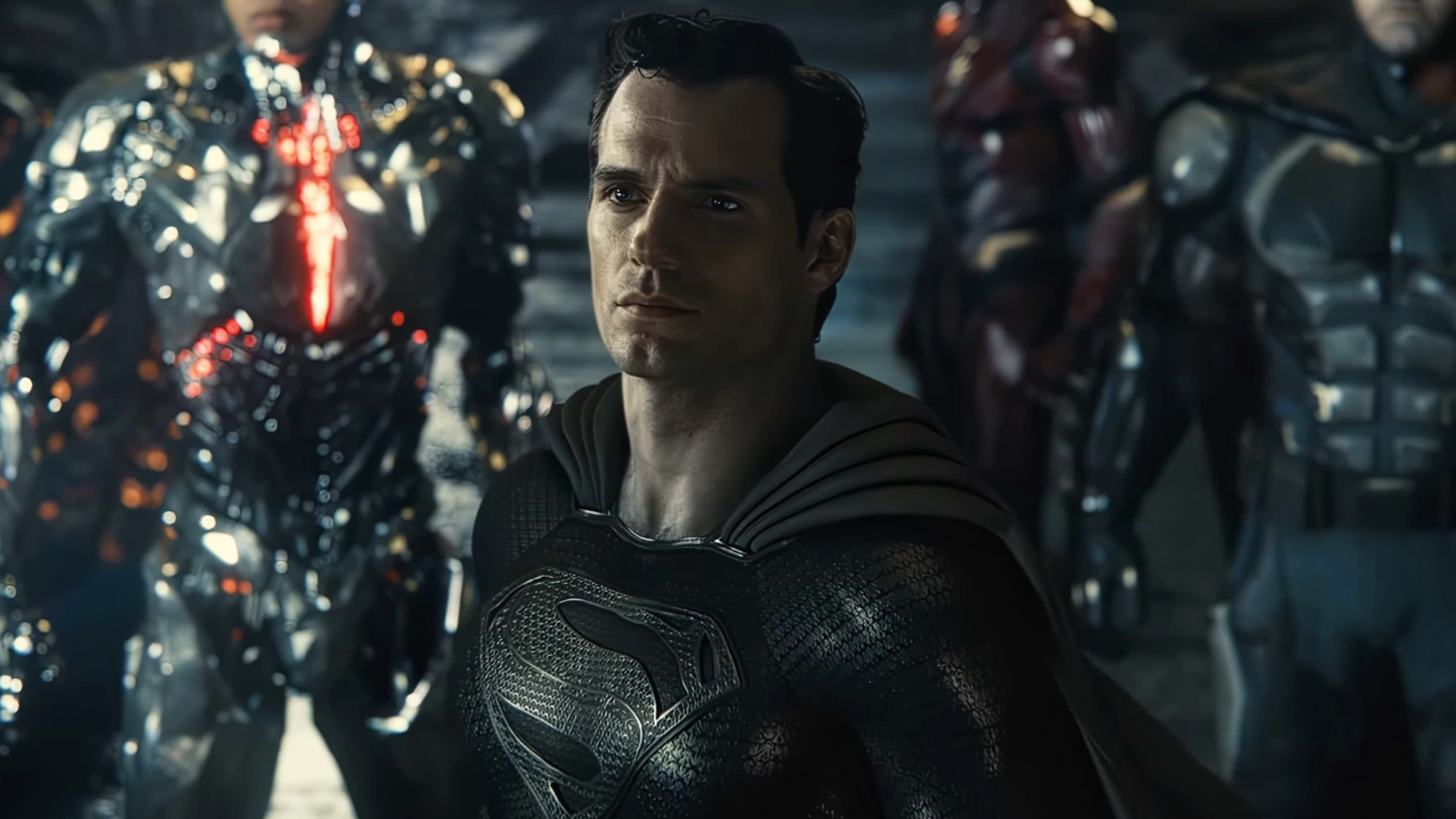 Henry Cavill front in center in his black Superman costume during Zack Snyder's cut of Justice League.