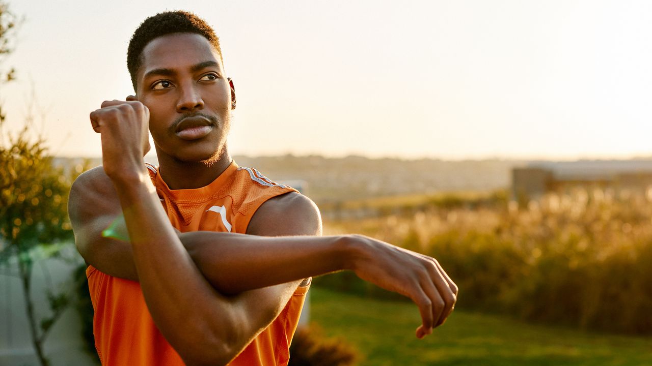 Man stretches his shoulder muscle