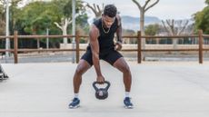 A man performing single arm kettlebell exercise