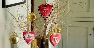 branches in vase with hanging heart decorations