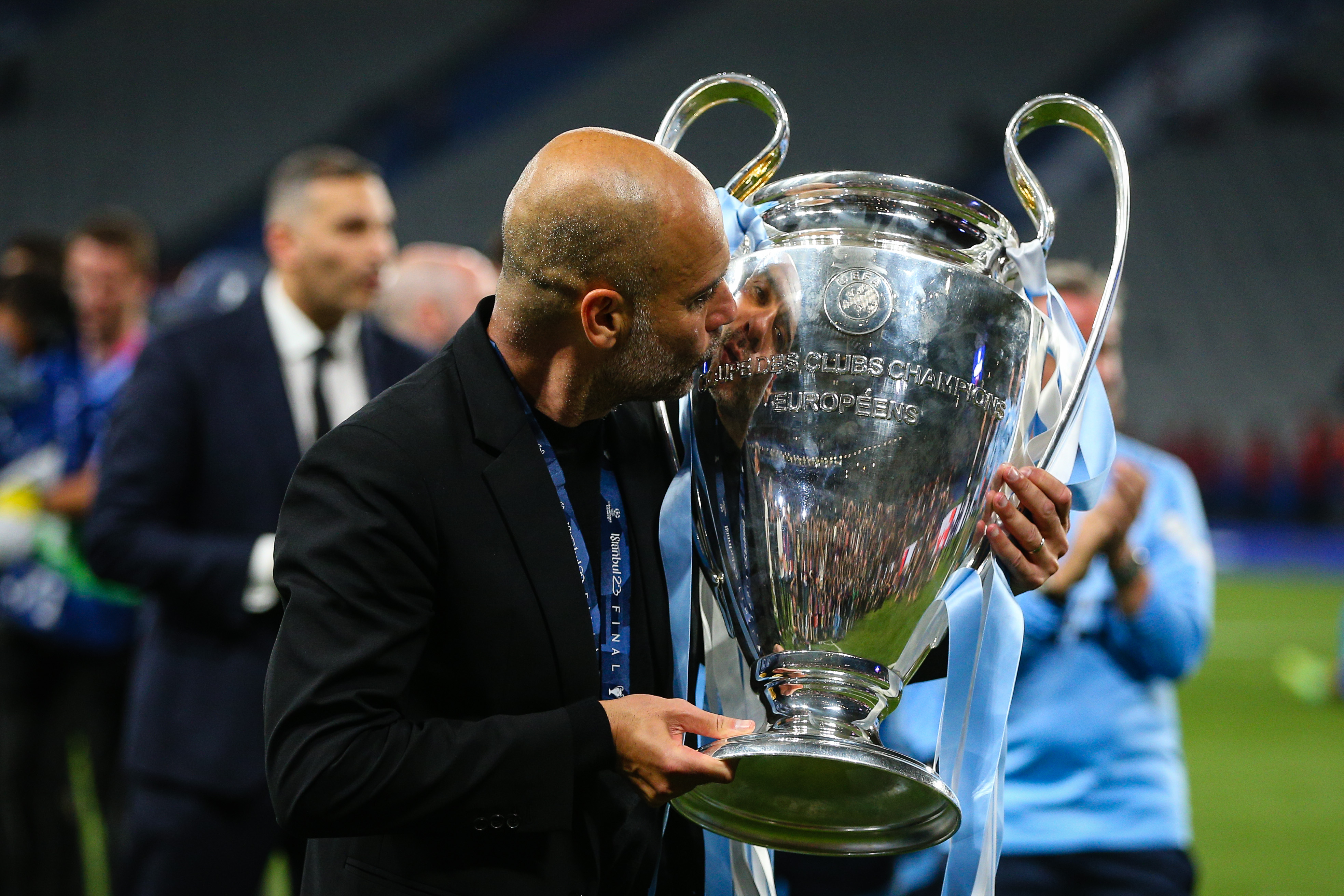 Pep Guardiola kisses the Champions League trophy after Manchester City's final win over Inter in June 2023.