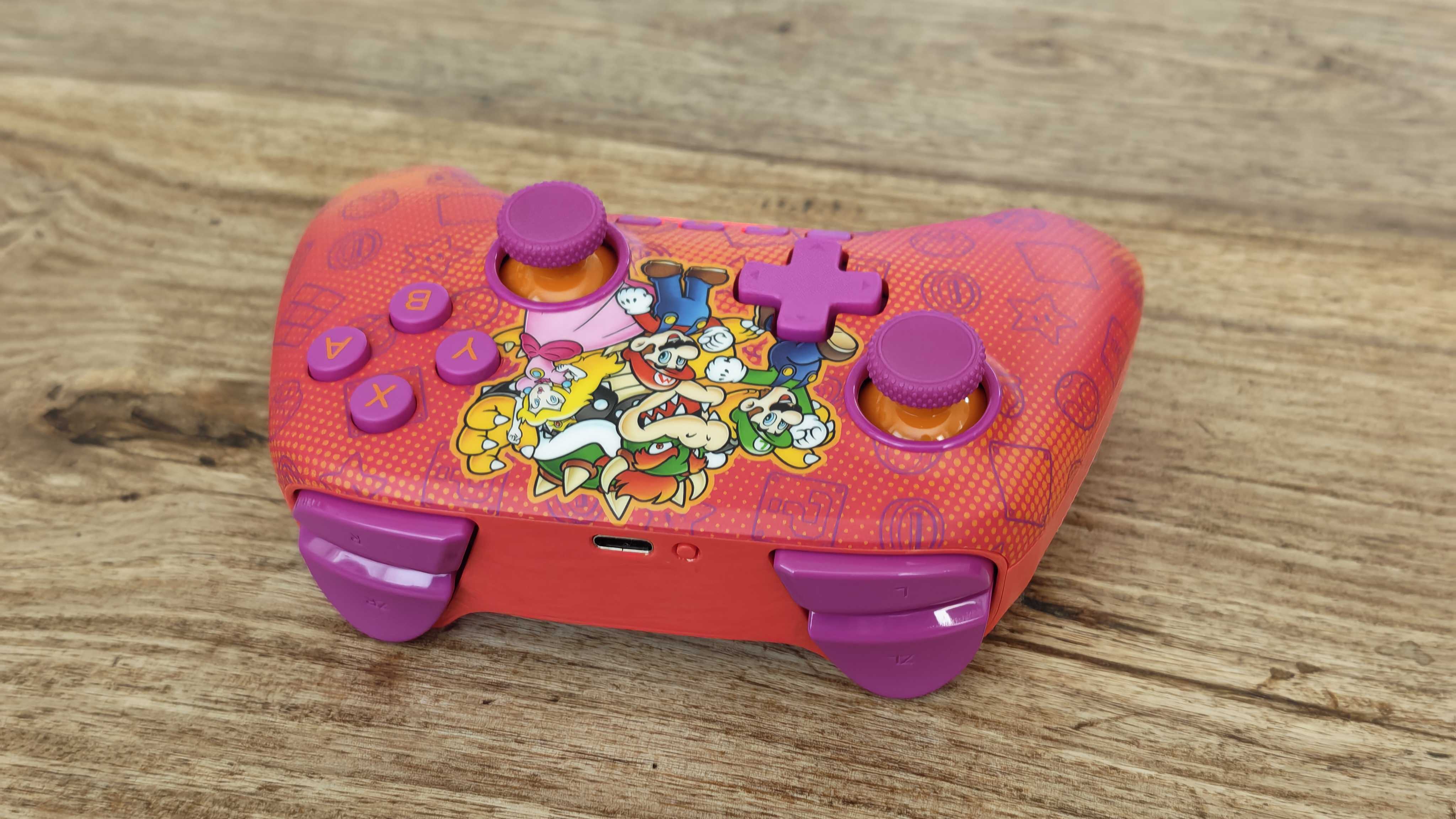 The PowerA Advantage Wireless Controller for Nintendo Switch 2 on a wooden table surface.