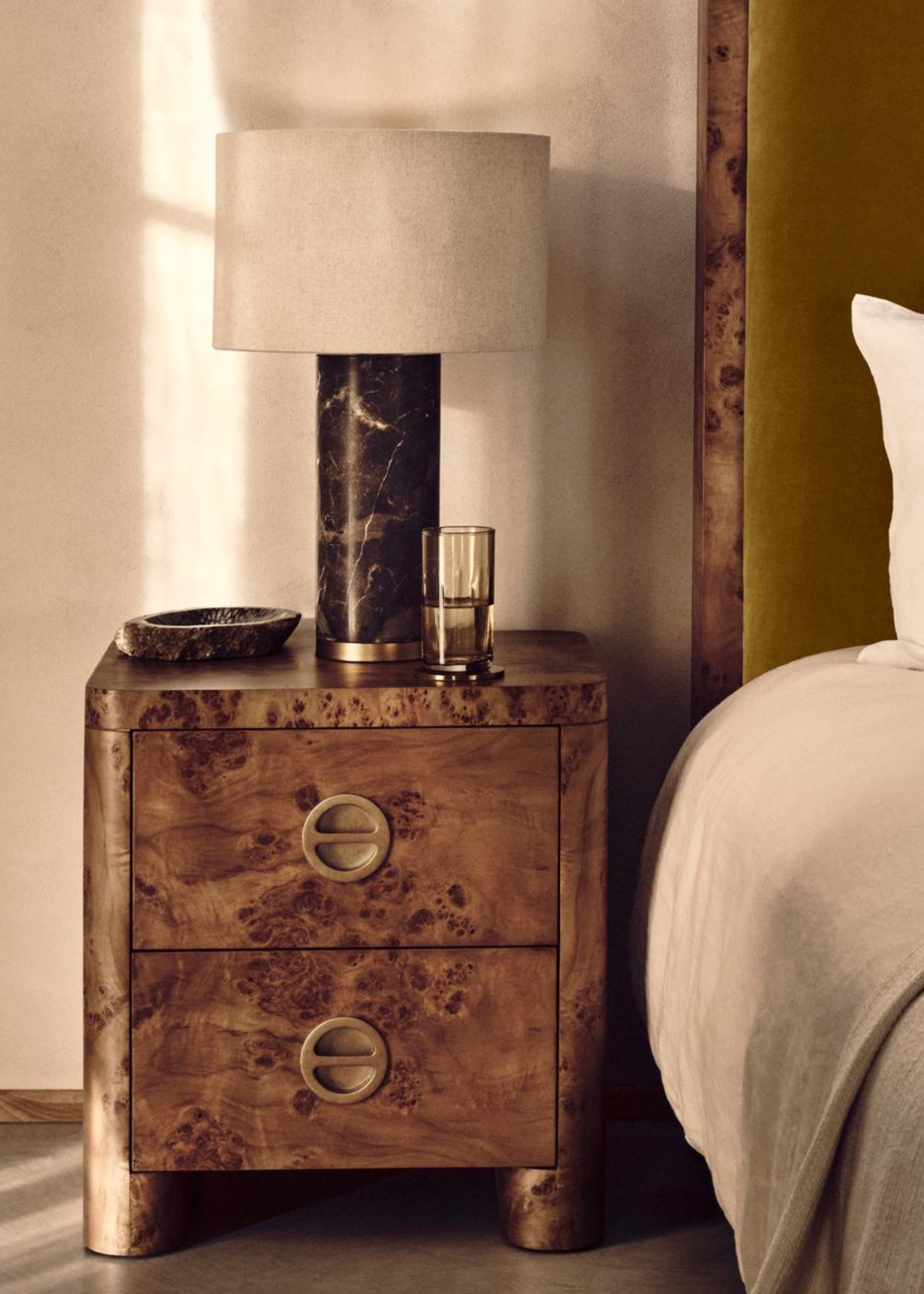 Soho Home Warwick Bedside Table, Mappa Burl, with a table lamp on top with a glass of water and a decorative tray