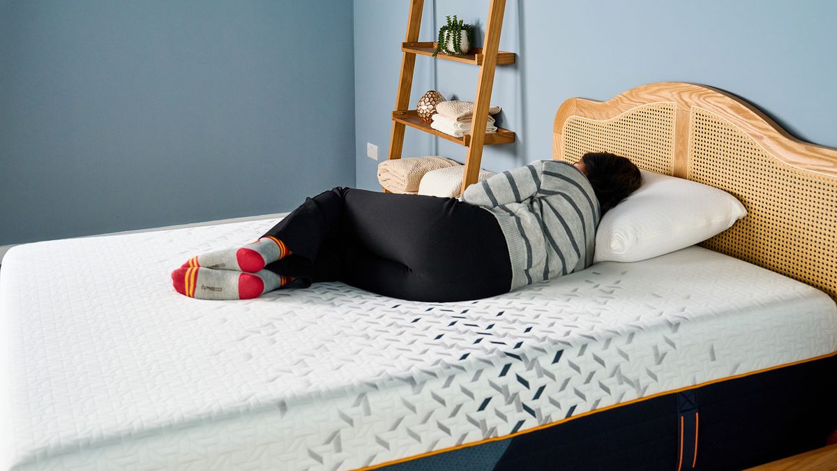 A female Tom's Guide mattress tester sleeping comfortably on her side on the Nectar Ultra Hybrid mattress