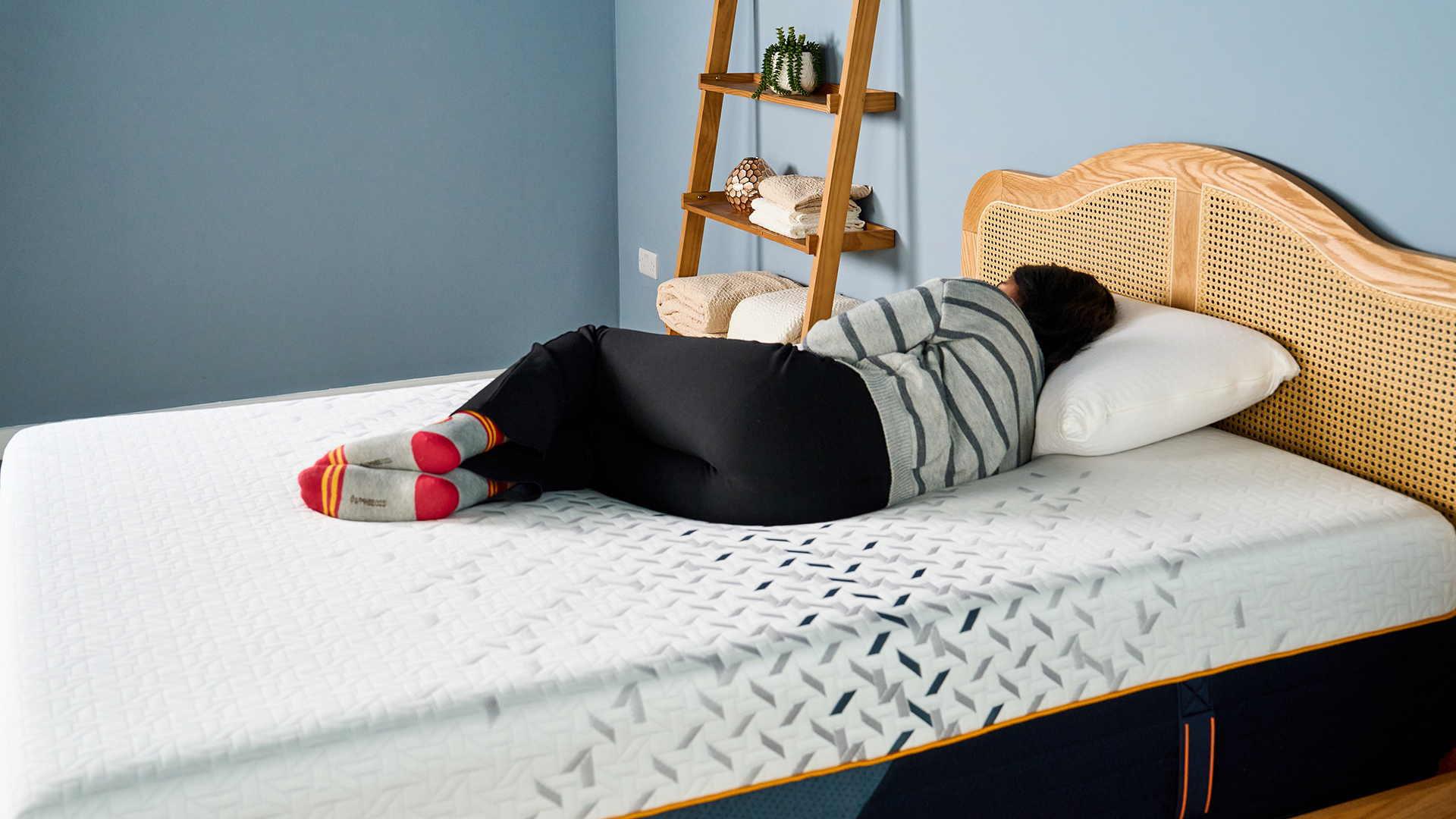 A female Tom's Guide mattress tester sleeping comfortably on her side on the Nectar Ultra Hybrid mattress