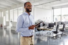 Happy fortysomething man talking during a business seminar in a coworking office.
