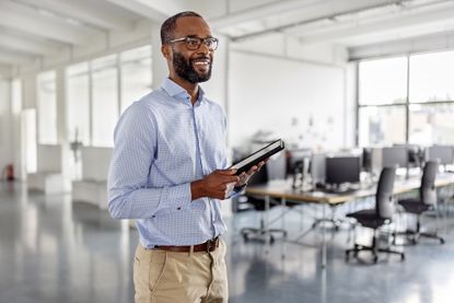 Happy fortysomething man talking during a business seminar in a coworking office.