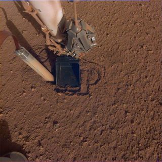 In this image from Oct. 26, 2019, the InSight Mars lander's heat probe, or "mole," is seen after backing about halfway out of the hole it had burrowed.