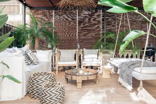 a decking seating area with a swinging day bed