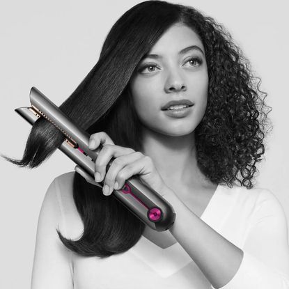 Dyson model with natural textured hair straightening her hair with the Dyson Corrale - dyson corrale black Friday 