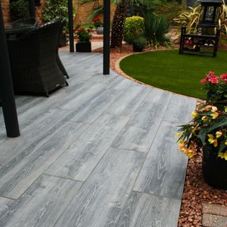 Grey wood effect patio tiles in garden