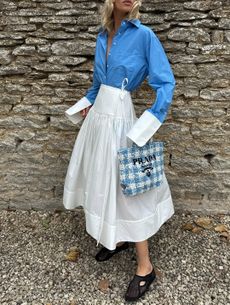 elsa hosk wearing white skirt blue shirt black shoes