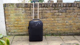 Think Tank Airport International V3.0 travel case next to a brick wall