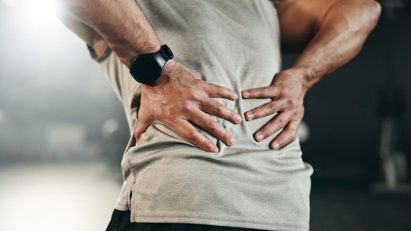 a man holding his back in pain