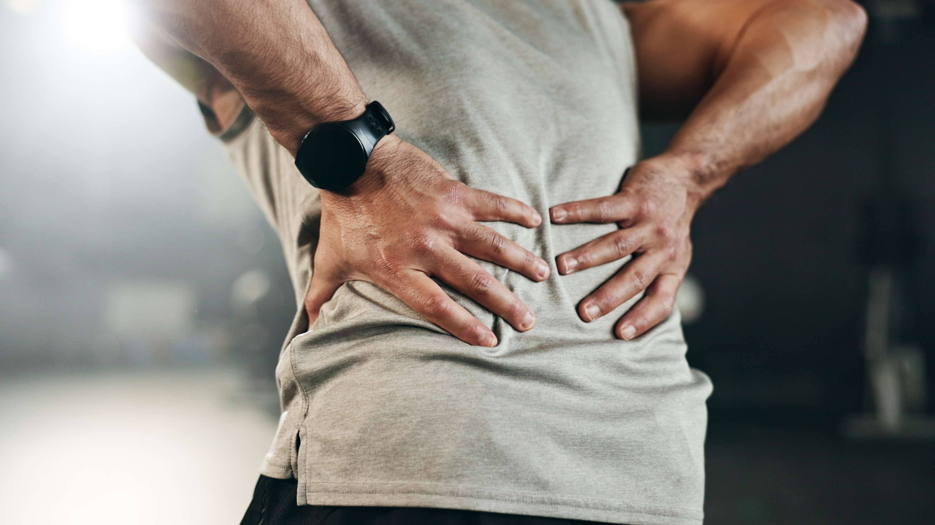 a man holding his back in pain