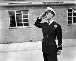 a photo of Prince Philip saluting as a Lieutenant in the Navy