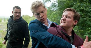Robert Sugden prepares to propose to Aaron Dingle he's stopped in his tracks by Lachlan White who is suspicious of his relationship with Rebecca and threatens he will pretend he sexually abused him. Furious Aaron overhears and bundles Lachlan in his boot in Emmerdale.