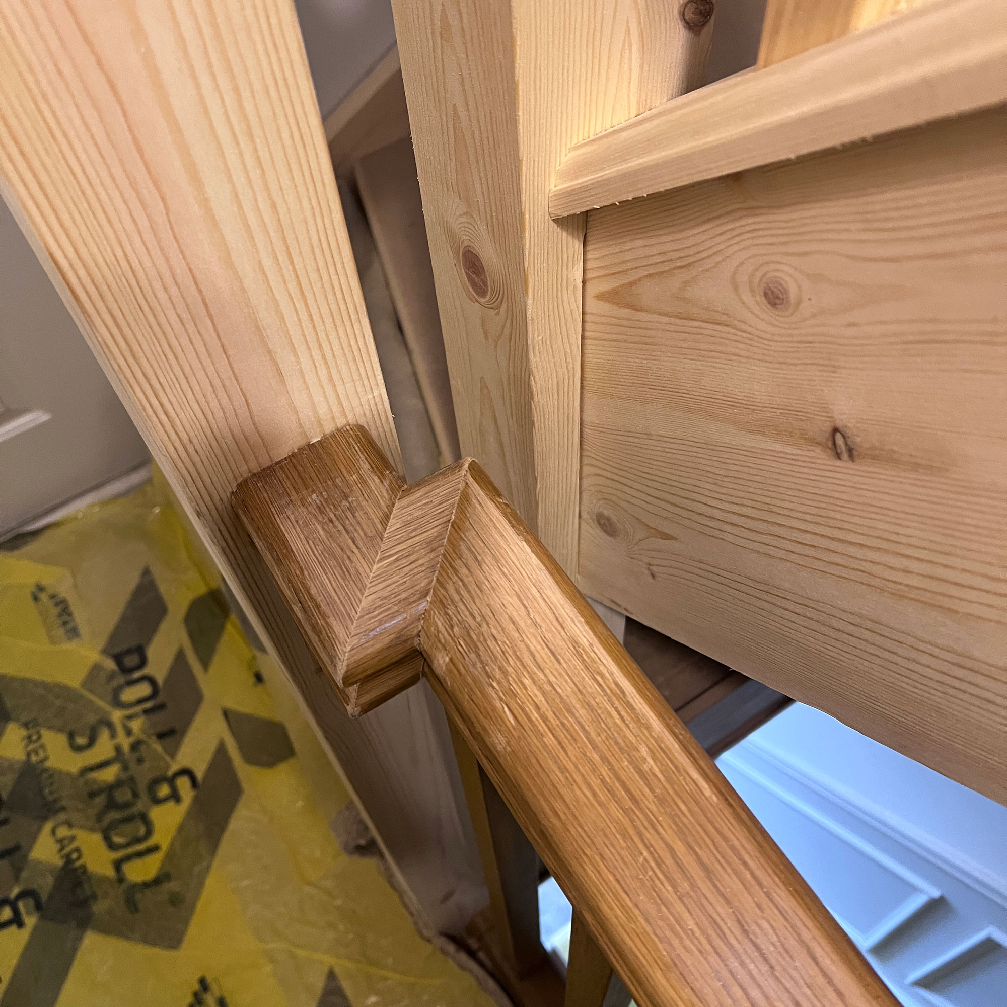 Close up of banister showing effects of wood stain