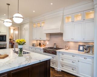 White kitchen with marble island