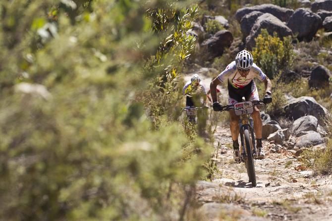 Christoph Sauser(Switzerland) of Burry Stander-Songo chases hard after a broken chain puts them behind during stage 2