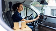 woman in car with delivery packages