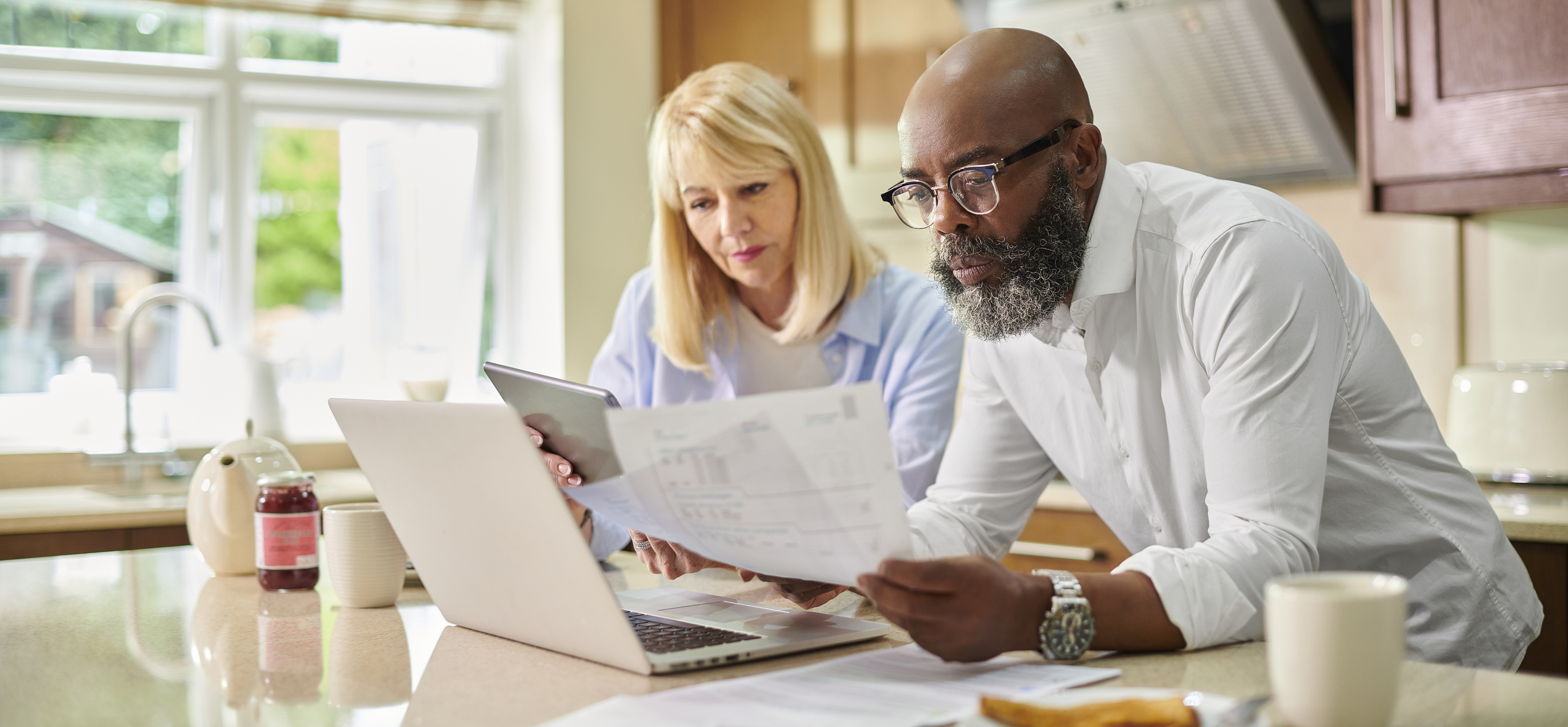 A senior couple looks over their finances together.